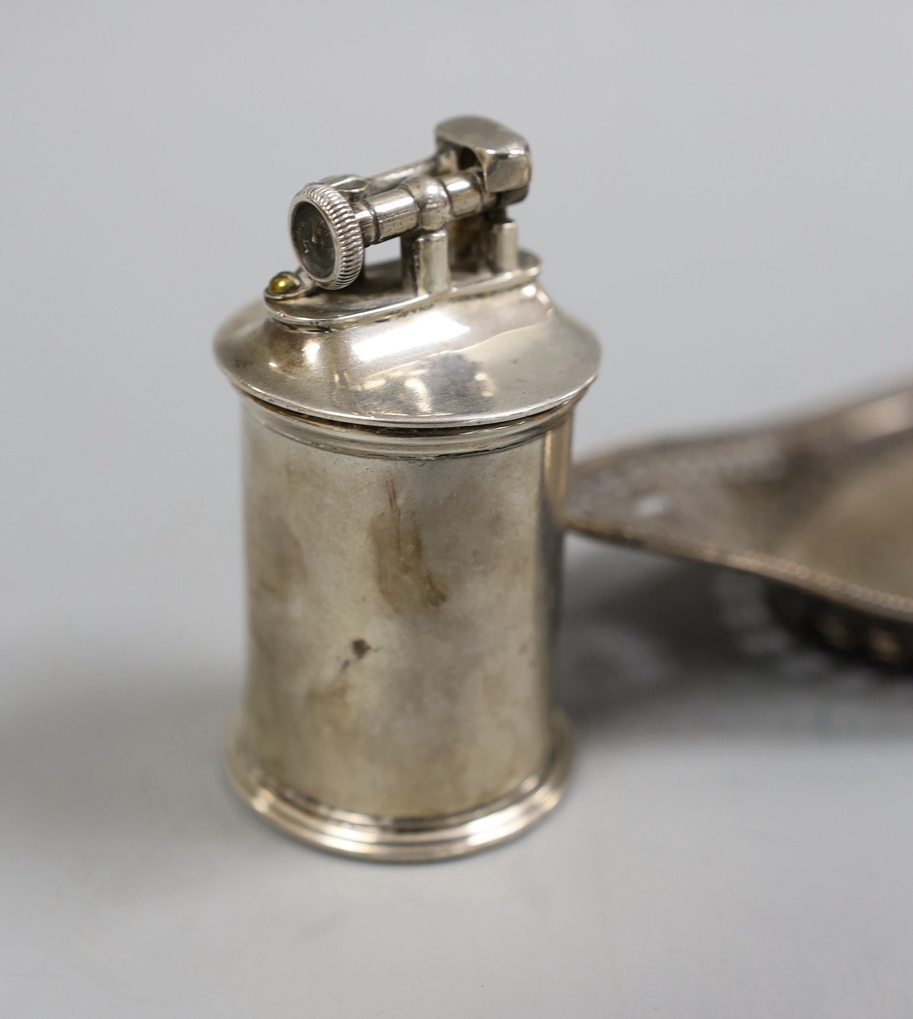A late Victorian pierced silver mounted navette shaped inkstand, with silver mounted single glass well, Charles Stuart Harris, London, 1896, 26.5cm, together with a 1920's 'The Classic' silver mounted cylindrical lighter